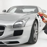 Silver sports car being polished with a professional car detailing buffer