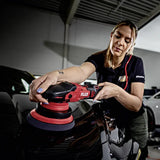 Woman using FLEX polisher on black car in garage, detailing auto surface with precision tool