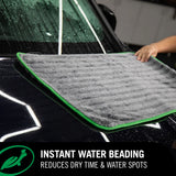 Microfiber towel drying wet car hood, demonstrating instant water beading at The Detailer's Emporium