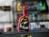 Meguiar's Quik Wax spray bottle for car detailing, shines as you dry, in red bottle on black surface