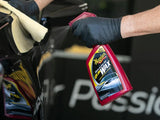 Meguiar's Quik Wax spray applied to black car with microfiber towel for glossy finish
