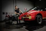 Professional detailing a classic red Porsche with FLEX polisher in garage