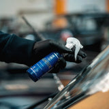 Hand in black glove holding Labocosmetica AQUAVÈLOX Glass Nano Sealant spray bottle