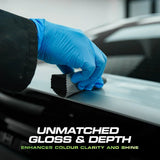 Applying Detail Ease Graphene Ceramic Coating to a car with a blue gloved hand and applicator.