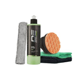 Car care product set with a bottle, sponge, and cloths on a light gray background.