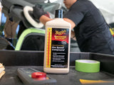 Meguiar's Mirror Glaze Pro Speed Compound for car detailing, shown with tools and a detailer at work
