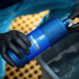 Hands in black gloves holding a bottle of Labocosmetica PURÌFICA Decontaminant Shampoo.