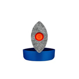 Grey polishing pad with orange center resting on a blue container