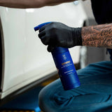 Hand in black glove holding a bottle of Labocosmetica SIDERO Iron Remover Gel.
