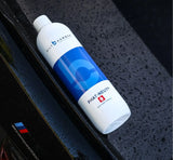 Bilt Hamber Phat-Neut multi-mode rinseless wash bottle on a wet black car surface