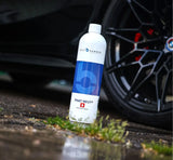 Bilt Hamber Phat-Neut multi-mode rim sealant bottle leaning against a black car wheel