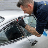 Professional detailing a silver car window using Labocosmetica mineral stain remover.