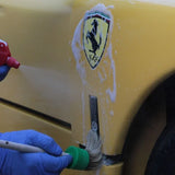 Using Labocosmetica ÈNERGO mineral stain remover and a detailing brush on a yellow car fender