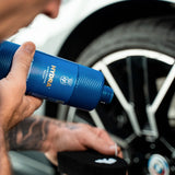 Person applying Labocosmetica HYDRA Hyper Dressing Sealant to a car wheel.