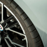 Close-up of a dressed car tire and rim treated with Labocosmetica HYDRA Hyper Dressing Sealant