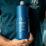 A person holding a bottle of Labocosmetica PRÌMUS 2.0 alkaline foam prewash.
