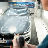 Labocosmetica PRÌMUS 2.0 prewash foam being applied to a grey luxury car.